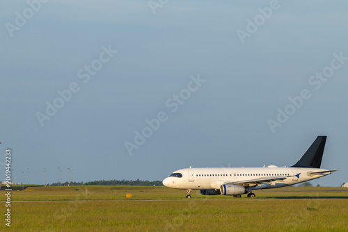 Passenger airplane taxiing on airport runway at Hostivice