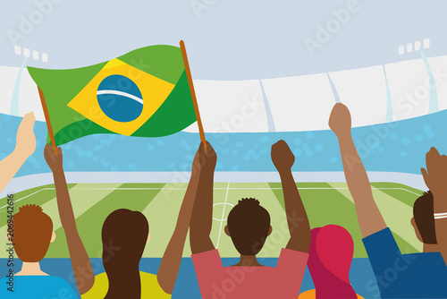 Crowd of fans waving Brazilian flag at soccer match in stadium during day