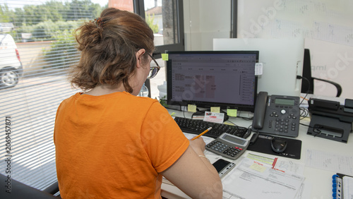 Photos Administrative secretary managing tasks and emails on computer with concentratio