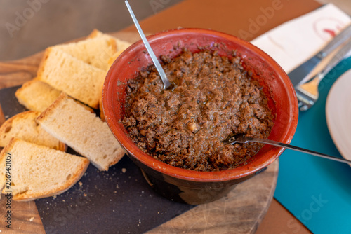 Tuscan crostini  are a classic and hearty Tuscan antipasto. They consist of slices of toasted bread  topped with a rich, dark pâté made with chicken livers, capers, anchovies, and Vin Santo wine.