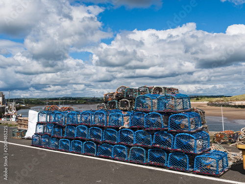Lobsterpots and marker flags at Amble, Northumberland, UK