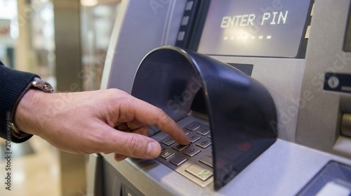 Person Using ATM Machine for Transaction