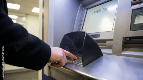 Person Using ATM Machine for Transaction