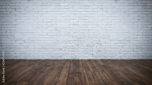 Empty interior room featuring a weathered white brick wall and dark brown polished hardwood flooring