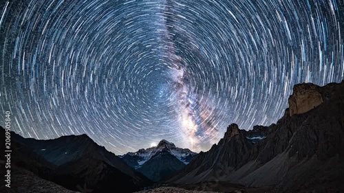 The Milky Way shines over a dark mountain range at night