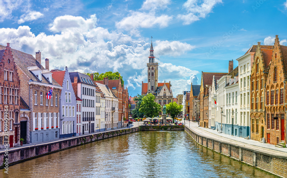 Fototapeta premium Bruges cityscape, Panoramic view of Brugge old town, Bruges city historic centre, water canal, Poortersloge tower, King's Bridge and medieval buildings on embankment, West Flanders province, Belgium