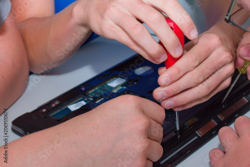 Laptop repair hands with tools