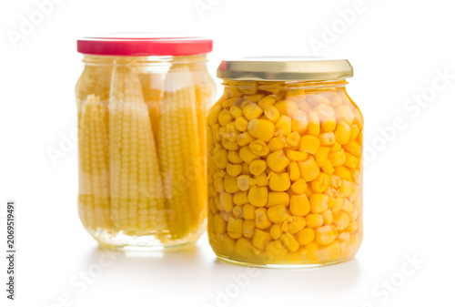 Foto Two Jars of Canned Corn and Baby Corn in Glass Jars on White Background, Preserv