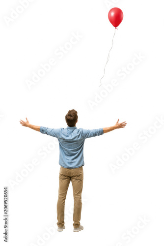 A man reaches toward a floating red balloon on white background. Space for text.