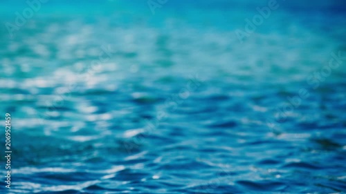 Calm blue ocean surface with gentle ripples closeup abstract sea water background texture, 4K