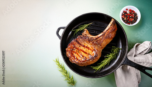 Grilled Pork Steak Tomahawk In A Pan On Bright Background