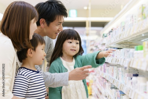 Japanese Family Comparing Products in a Drugstore