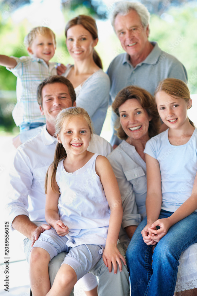 Obraz premium Portrait, big family and happy generations outdoor for bonding, love and care on patio. Grandparents, parents and children with people on porch, smile and relax together for trust and memory