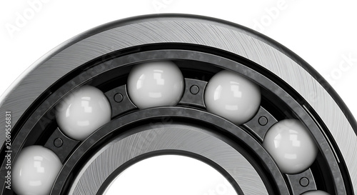 Close up of a metallic ball bearing with white ceramic balls inside a dark steel housing showing precise engineering detail