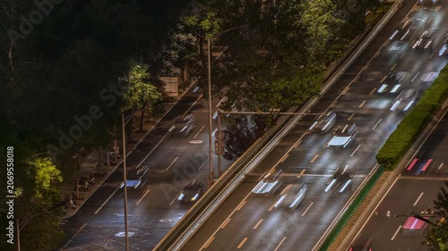 Long exposure light trail time-lapse of urban night scene elevated traffic flow