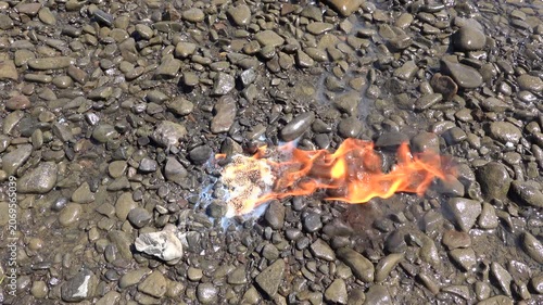 Burning napalm on the shore of a lake, made at home from soap and gasoline
