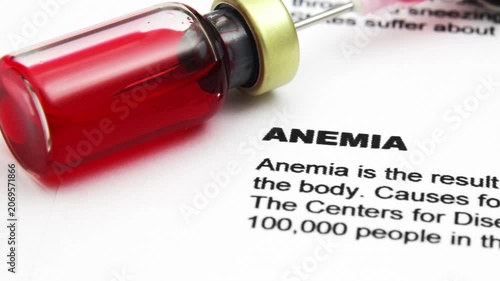 Anemia Diagnosis Concept with Blood Sample Vial and Medical Report