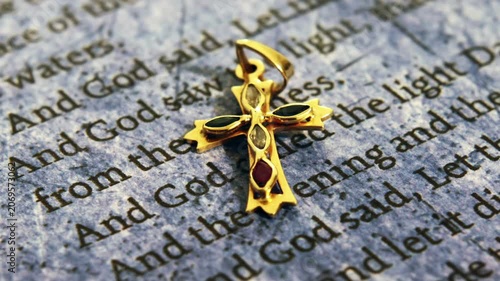 Gold Cross Pendant on Bible Scripture Symbolizing Christian Faith and Spirituality
