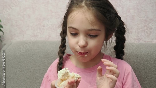 Eating, cupcake and portrait of child for dessert, sweet treat or sugar snack . Bite, tasting and girl with vanilla cake for confection, hungry and enjoy delicious food. Happy childhood: a child enjoy