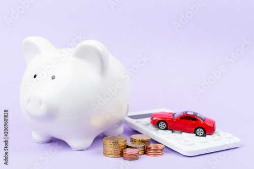 Piggy bank with money and model of car on color background