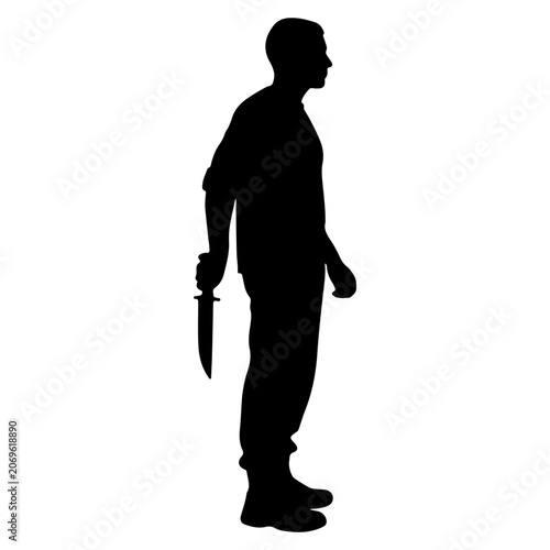 Silhouette of a man holding a knife behind his back.