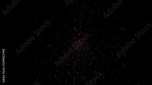 Exploding fireworks illuminate the dark night sky with dazzling light and color