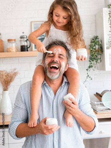 Father and Daughter Having Fun Baking Together in Kitchen