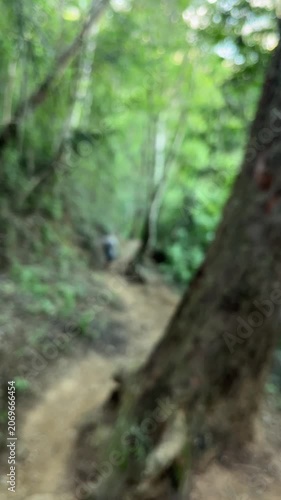 Senior man jogging on forest trail blurred outdoor exercise background