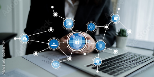 Foto A business professional engages with various digital technology icons in a modern workspace, emphasizing the importance of data security and connectivity in today business environment