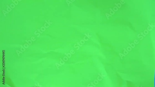 White paper tearing open horizontally to reveal green screen for creative video framing design concept vfx animation transition element with blue key background