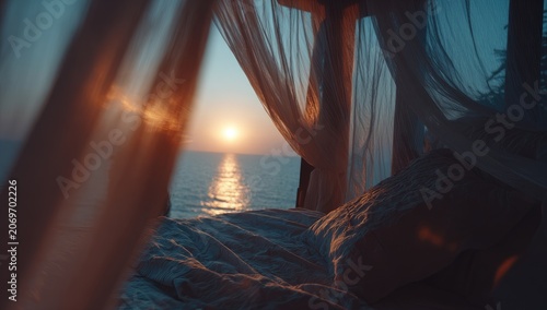 Sunrise view from a bed draped in sheer fabric