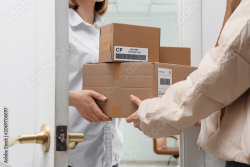 Young woman receiving parce...