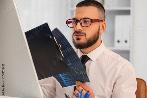 Male trader in eyeglasses w...