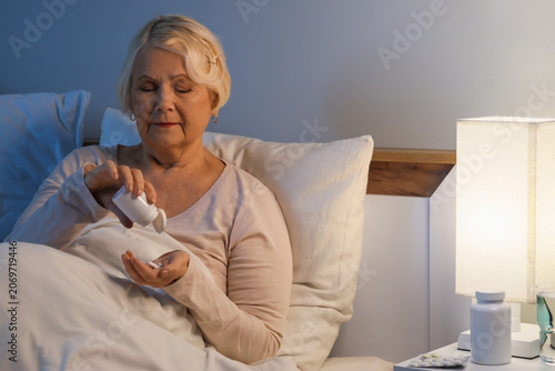 Senior woman taking pills f...