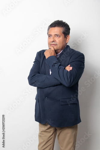 60-year-old Latino man with dark skin appears happy and at peace, enjoying a successful professional and personal life