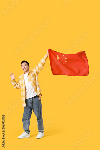 Young Asian man with flag o...