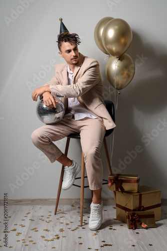 Young man with disco ball c...