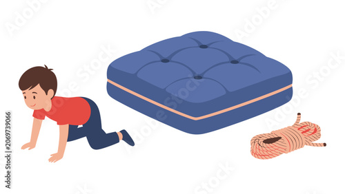 Young boy crawling towards a large blue mattress with a coil of rope nearby.