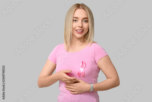 Young woman with pink ribbo...