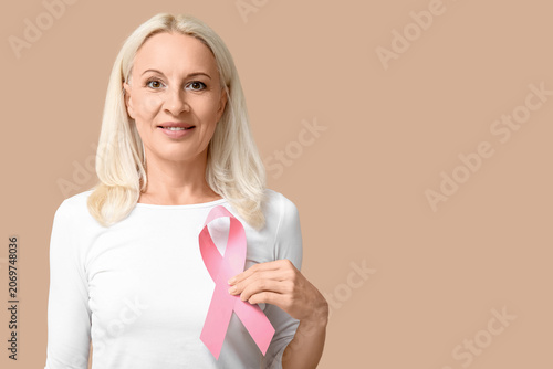 Mature woman with pink ribb...