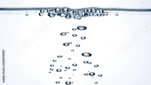 Macro Underwater Bubble Ascending to Surface in Pure Blue Water