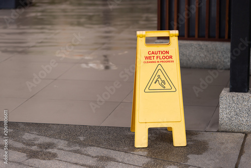 Wet floor warning sign placed outdoors