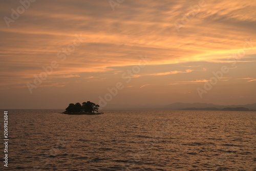 Canvas Print Island silhouette in golden sunset sea in early summer, Japan