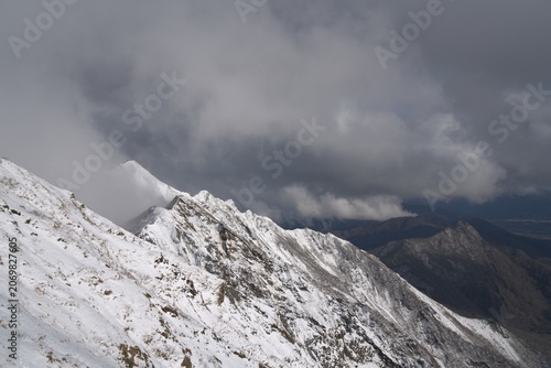 Snowy ridge under dramatic sky in winter, Japan
