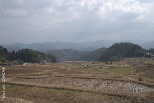 Terraced rice fields in mountain valley in spring, Japan