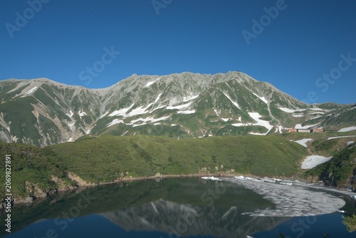 Alpine pond reflecting mountains in summer, Japan