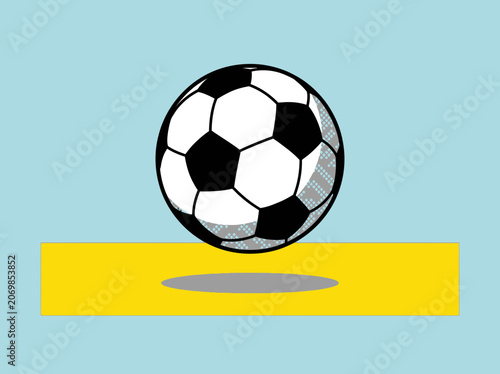 A classic black and white soccer ball suspended mid-air over a yellow stripe on a light blue background.