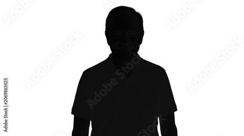 Silhouette of person wearing black polo shirt standing alone