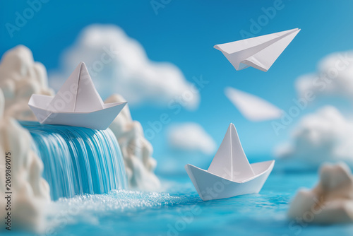 three paper boats, transitioning into paper airplanes, are depicted above and on a vibrant blue body of water with a cascading waterfal