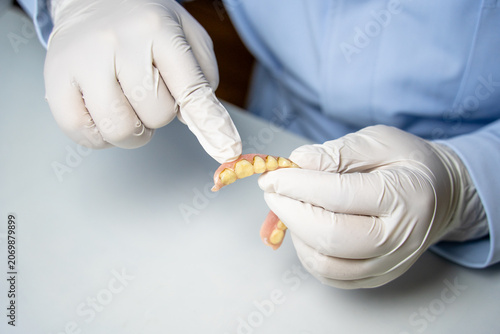 Fotografie Dental professional holding removable partial denture for display